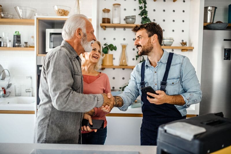 Home-service-with-Customer Home service expert shaking his customers hand