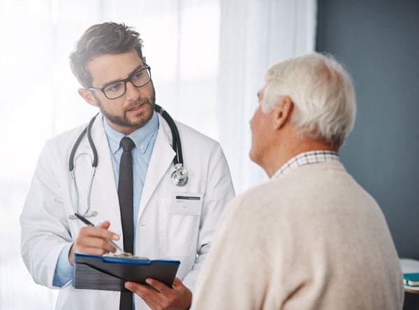 Dr-with-Patient Doctor speaking with a patient