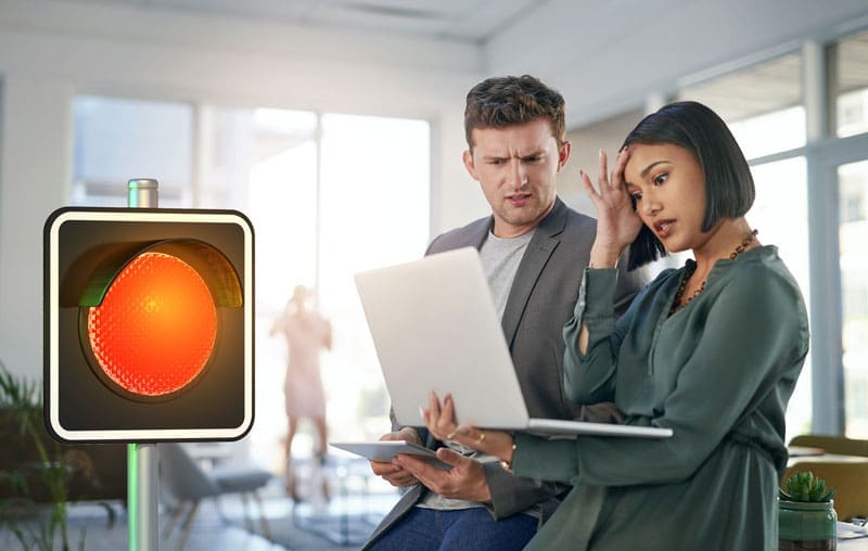 Red-Light-Business-frustrated-owner 2 Business owners looking at their suspended google business listing with a red light overlapping the image